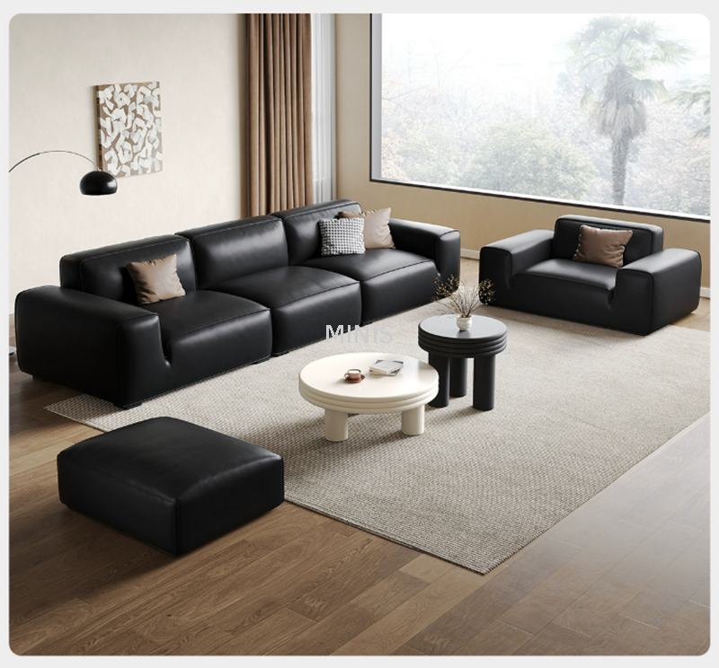 Living room styled around a modern black sofa